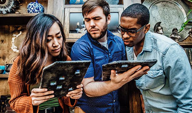 Escape room participants glancing at map