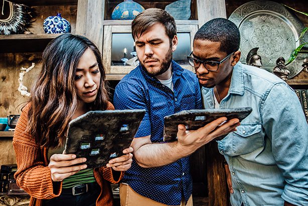 Escape room participants glancing at map
